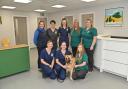 Dereham Vets opens their new premises in the town. Flo Scott director of the practice (back row, centre) with Phoebe, one of her staff's dog