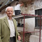 Dr Peter Wade-Martins, Dereham Heritage Trustee, as work is carried out to restore the decorative pargeting on the 500-year-old Bishop Bonner's Cottage