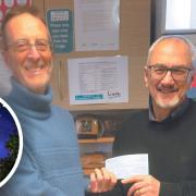 Mike Webb, chairman of aboutDereham hands over the donation cheque raised through the sale of calendars to Keith Mersh, chairman of Love Dereham