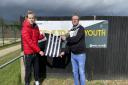 Todd Cantwell and Andrew Wright, vice-chair of Dereham Town Youth FC, with the kit donated from 4Sports