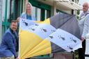 Maxine O’Mahoney, Chief Executive of Breckland Council, Cllr Terry Jermy (kneeling) deputy chairman of Breckland Council and Chairman of Breckland Council, Cllr Peter Wilkinson (right) preparing to fly the flag for Norfolk at our head offices in