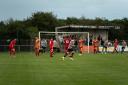 Dereham Town in action against Walsham le Willows FC at Aldiss Park