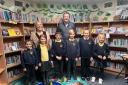 Mrs Jennie Muller, headteacher with Leroy Burrell chair of governors and children from Yaxham CofE Primary Academy - Credit: Jungle PR Ltd