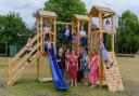 Children and staff celebrate the unveiling of new play equipment at Thomas Bullock CE Primary Academy in Shipdham, near Dereham