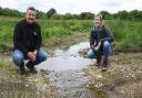 Andy Millar, Natural England senior advisor for nature recovery in Norfolk and Suffolk, and Rosie Begg, landowner, at the meandering chalk stream created as part of the Wendling Beck Environment Project at Gressenhall