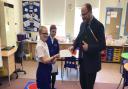 Year six pupil Olivia handing her letter to Mid Norfolk MP George Freeman at Brisley Primary Academy