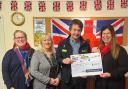 Nick Deree, store manager at Dereham's Original Factory Shop hands over the cheque to Dereham Cancer Care