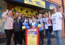 Leanne Jarman, second left, Morrisons community champion, and Ian Odgers, right, organisers, celebrate the opening of the Dereham Ukraine aid centre with some of Dereham's Ukrainians.