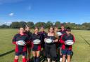 Katherine Voyce, Community Coordinator for Konectbus, hands over the set of rugby balls to members of Neatherd High School ‘s rugby teams.