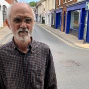 Richard Hawker with the loose manhole cover on Dereham's High Street