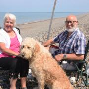 Irene and David Duncan, with Leo the dog, enjoying the hot weather at Weybourne beach near Holt as a heatwave hits Norfolk.