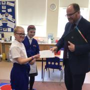 Year six pupil Olivia handing her letter to Mid Norfolk MP George Freeman at Brisley Primary Academy