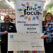Pauline Hicks (second from right), from Fakenham charity First Focus, accepting Dereham Co-op\'s donation