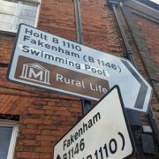 Norfolk County Council has said it will cover up the swimming pool which has reappeared on a road sign in Dereham Town Centre