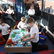 Litcham Primary School children enjoying their new play bus